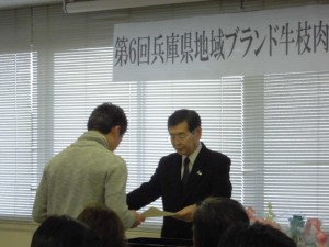 2015年2月6日(金)　兵庫県地域ブランド牛枝肉共励会　個人の部　神戸肉流通推進協議会会長賞　最優秀賞の表彰（神戸肉流通推進協議会・上羅会長）